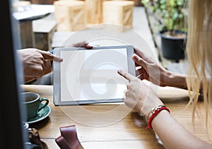 Couple using digital tablet in a cafe