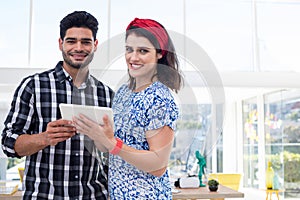 Couple using digital tablet in the office