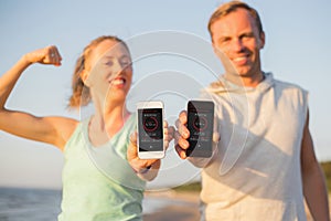 Couple using fitness app on their mobile phones