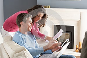 Couple Using Laptop And Discussing Household Bills