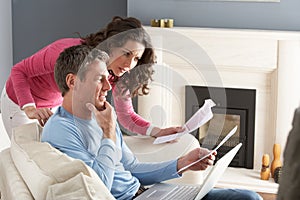 Couple Using Laptop And Discussing Household Bills