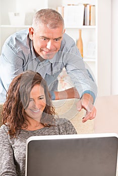 Couple using laptop at home