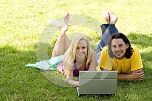 Couple using laptop outdoors