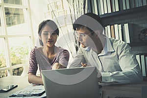 Couple using laptop working together at home