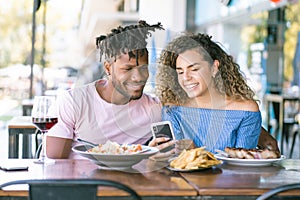 Couple using a mobile phone at a restaurant.