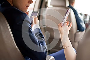 Couple using moblie phone in a car