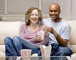 Couple using sharing chinese take-out