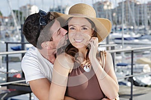 Couple using smartphone kissing o networking outdoors