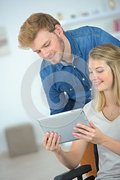 Couple using tablet computer