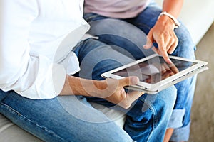 Couple using a tablet computer in their living room