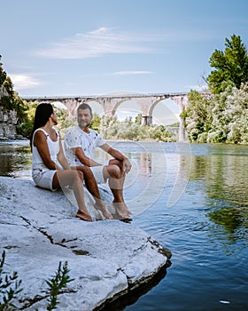 Couple on vacation in Ardeche France, view of the village of Vogue in Ardeche. France