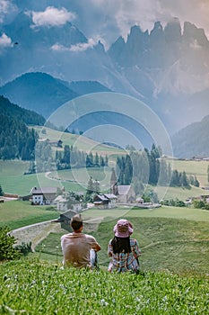 Couple on vacation in the Dolomites Italy, Santa Magdalena Village in Dolomites area Italy Val di Funes