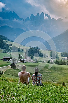 Couple on vacation in the Dolomites Italy, Santa Magdalena Village in Dolomites area Italy Val di Funes