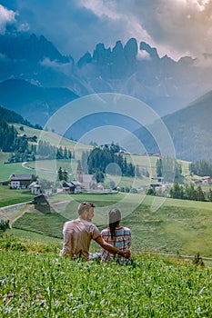 Couple on vacation in the Dolomites Italy, Santa Magdalena Village in Dolomites area Italy Val di Funes