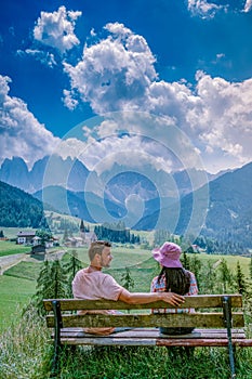 Couple on vacation in the Dolomites Italy, Santa Magdalena Village in Dolomites area Italy Val di Funes