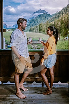 Couple on vacation in the Dolomites Italy, small church during cloudy foggy weather, San Vigilio di Marebbe,South Tirol photo