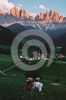 couple on vacation in the Italian Dolomites, Santa Maddalenavillage with magical Dolomites mountains in autumn, Val di