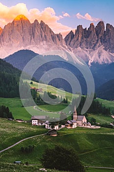 couple on vacation in the Italian Dolomites,Santa Magdalena village with magical Dolomites mountains in autumn, Val di