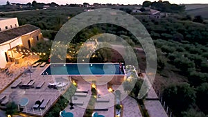 Couple on vacation at luxury resort in Sicily during sunset by the infinity pool in Sicilia Italy