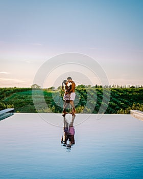 couple on vacation at luxury resort in Sicily during sunset by the infinity pool in Sicilia Italy