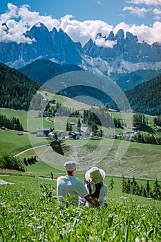 Couple on vacation Santa Magdalena Village in Dolomites area Italy, couple on vacation Val Di Funes Italian Dolomites