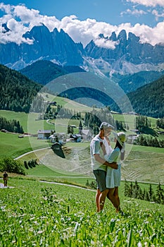 Couple on vacation Santa Magdalena Village in Dolomites area Italy, couple on vacation Val Di Funes Italian Dolomites