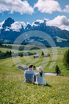 Couple on vacation Santa Magdalena Village in Dolomites area Italy, couple on vacation Val Di Funes Italian Dolomites