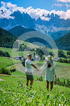 Couple on vacation Santa Magdalena Village in Dolomites area Italy, couple on vacation Val Di Funes Italian Dolomites