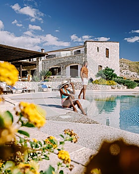 a couple on vacation at Sicilian Agriturismo relaxing by the pool, bed and breakfast Sicily Italy