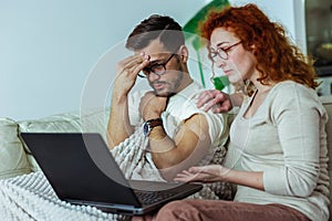 Couple after vaccination having medical teleconsultation using laptop at home