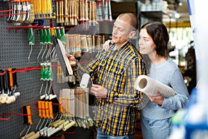 Couple with various goods in a hardware store