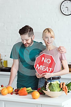 couple of vegans with no meat sign