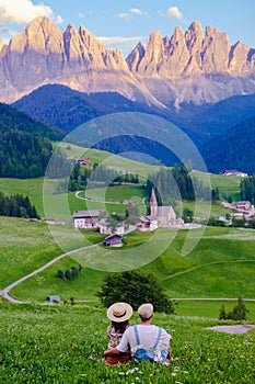 Couple viewing the landscape of Santa Maddalena Village in Dolomites Italy