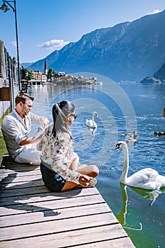 Couple visit Hallstatt village on Hallstatter lake in Austrian Alps Austria