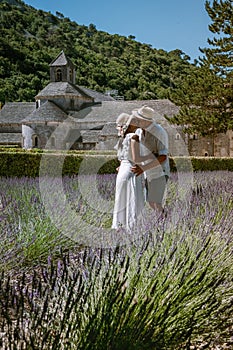 Couple visit the old town of Gordes Provence,Blooming purple lavender fields at Senanque monastery, Provence, southern