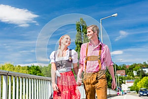 Couple visiting Bavarian fair having fun