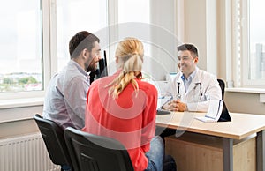 Couple visiting doctor at family planning clinic photo