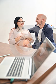 Couple visiting gynecologist office, rejoicing news that baby developing well