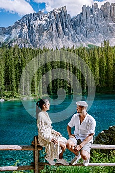 couple visit a bleu lake in the dolomites Italy, Carezza lake Lago di Carezza, Karersee photo