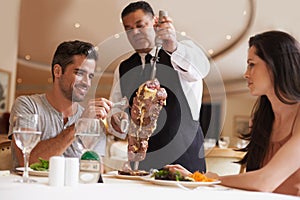 Couple, waiter and service for dinner in restaurant with meat, happiness and fine dining for anniversary or honeymoon