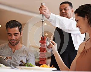 Couple, waiter and service for lunch in restaurant with meat, happiness and fine dining for anniversary or honeymoon