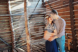 Couple waiting for baby photo shoot in a wooden house