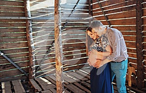 Couple waiting for baby photo shoot in a wooden house