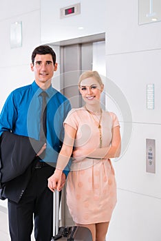Couple waiting for hotel elevator or lift