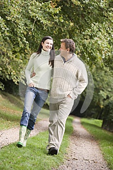 Couple on walk along woodland path