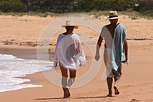 A couple walking along a beach