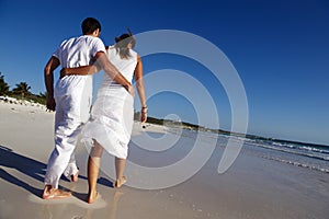 Couple walking along beach photo