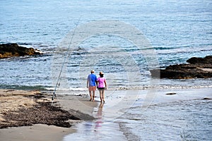 Couple walking along coastline