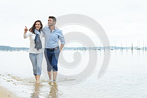 couple walking along tideline