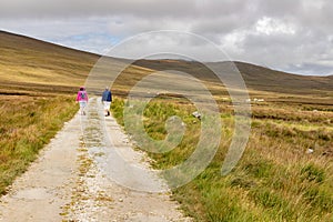 Couple walking around bogs with mountains in background